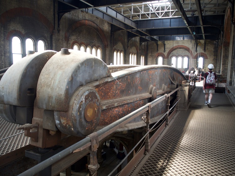 Looking from one end of a large, rusted metal beam.